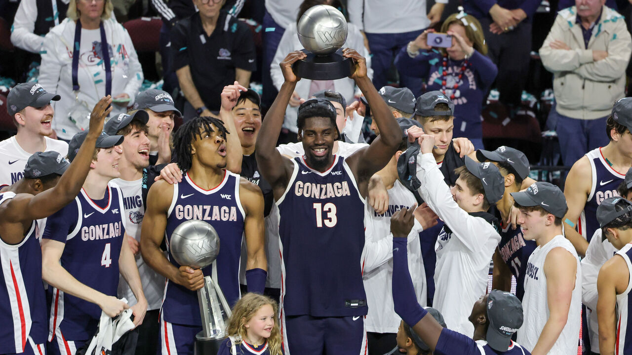 LAS VEGAS, NEVADA - MARCH 11: Graham Ike #13 of the Gonzaga Bulldogs hoists the Most Outstanding Player award as Michael Ajayi #1 of the Gonzaga Bulldogs holds the championship trophy after the Bulldogs' 58-51 victory over the Saint Mary's Gaels to win the championship game of the West Coast Conference men's basketball tournament at the Orleans Arena on March 11, 2025 in Las Vegas, Nevada.