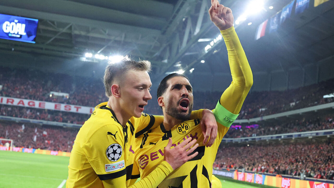 TOPSHOT - Borussia Dortmund's German midfielder #23 Emre Can (R) celebrates with Borussia Dortmund's German forward #14 Maximilian Beier (L) after he scored his team's first goal during the UEFA Champions League last 16, second leg football match between OSC Lille and Borussia Dortmund at the Pierre Mauroy stadium in Lille, northern France, on March 12, 2025.