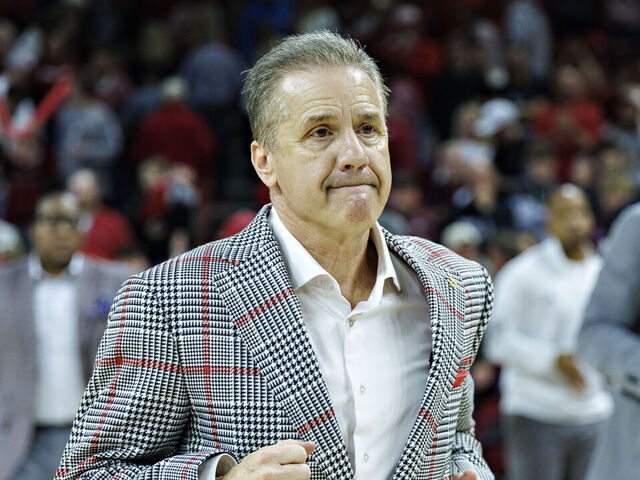 FAYETTEVILLE, ARKANSAS - MARCH 08: Head Coach John Calipari of the Arkansas Razorbacks jogs off the court after a game against the Mississippi State Bulldogs at Bud Walton Arena on March 08, 2025 in Fayetteville, Arkansas. The Razorbacks defeated the Bulldogs 93-92.