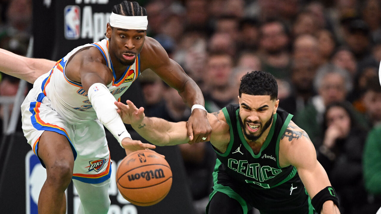 BOSTON, MASSACHUSETTS - MARCH 12: Shai Gilgeous-Alexander #2 of the Oklahoma City Thunder and Jayson Tatum #0 of the Boston Celtics reach for the ball during the fourth quarter at the TD Garden on March 12, 2025 in Boston, Massachusetts.