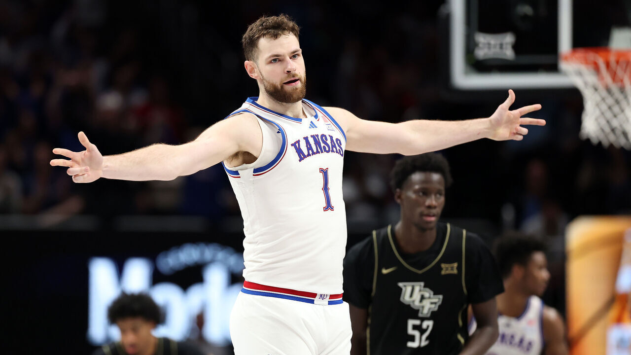 KANSAS CITY, MISSOURI - MARCH 12: Hunter Dickinson #1 of the Kansas Jayhawks reacts after hitting a three-pointer during the second round game of the Big 12 men's basketball tournament against the UCF Knights at T-Mobile Center on March 11, 2025 in Kansas City, Missouri.