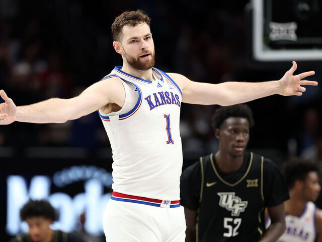 KANSAS CITY, MISSOURI - MARCH 12: Hunter Dickinson #1 of the Kansas Jayhawks reacts after hitting a three-pointer during the second round game of the Big 12 men's basketball tournament against the UCF Knights at T-Mobile Center on March 11, 2025 in Kansas City, Missouri.