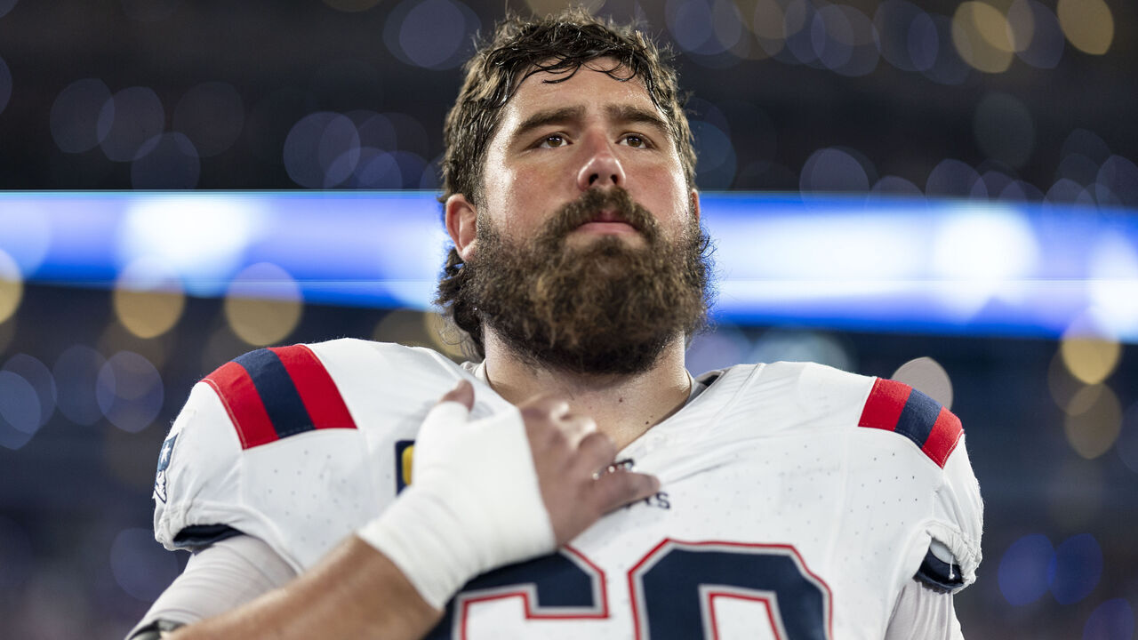 EAST RUTHERFORD, NEW JERSEY - SEPTEMBER 19: David Andrews #60 of the New England Patriots looks on during the national anthem prior to an NFL football game between the New York Jets and the New England Patriots at MetLife Stadium on September 19, 2024 in East Rutherford, New Jersey.