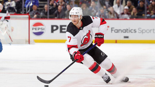 DENVER, COLORADO - FEBRUARY 26: Dougie Hamilton #7 of the New Jersey Devils skates against Sam Malinski #70 of the Colorado Avalanche at Ball Arena on February 26, 2025 in Denver, Colorado.