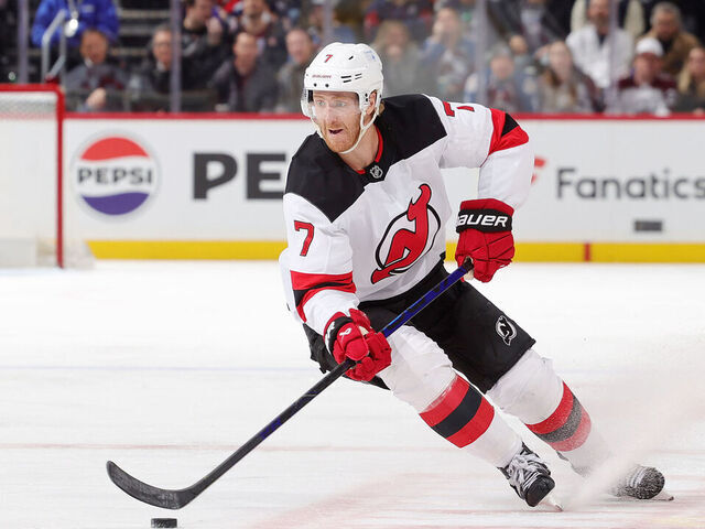 DENVER, COLORADO - FEBRUARY 26: Dougie Hamilton #7 of the New Jersey Devils skates against Sam Malinski #70 of the Colorado Avalanche at Ball Arena on February 26, 2025 in Denver, Colorado.