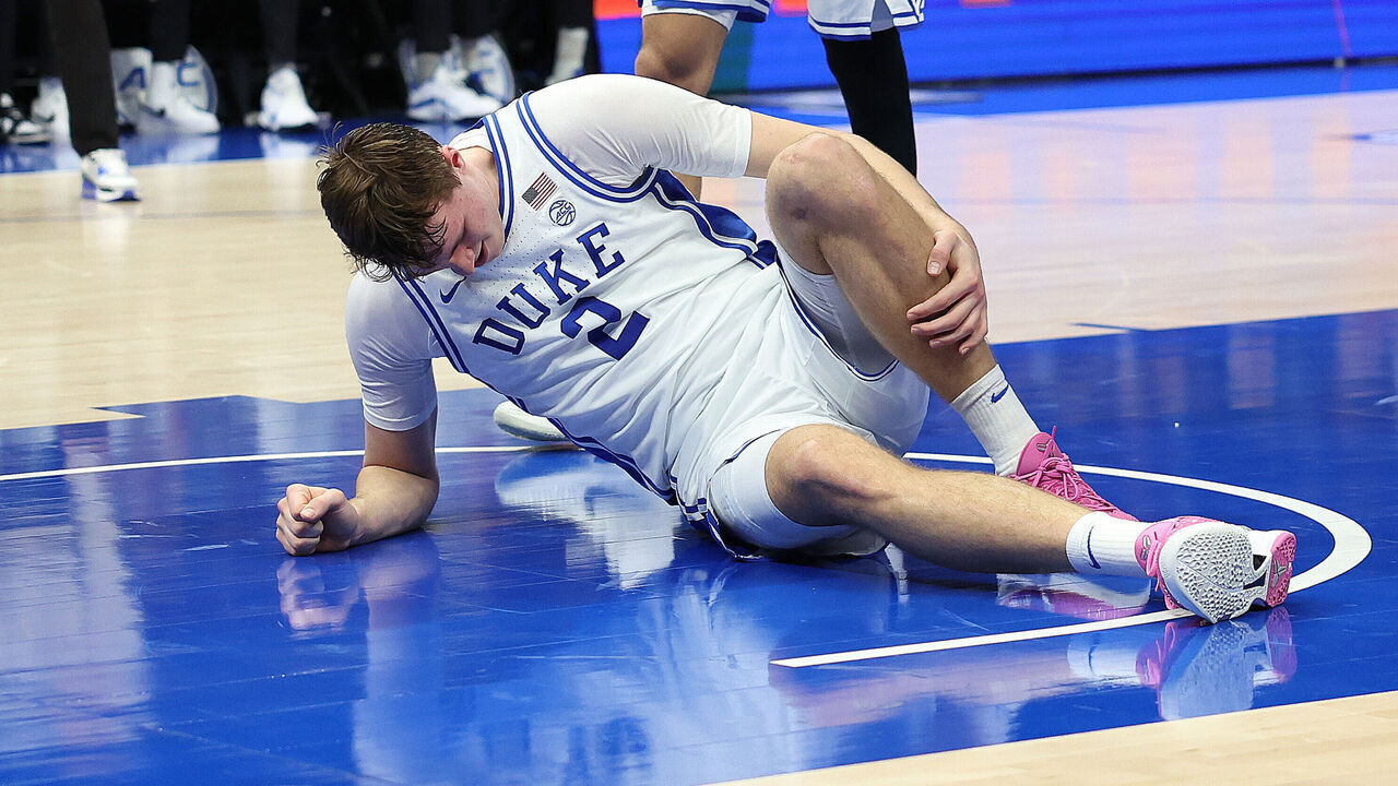 CHARLOTTE, NC - MARCH 13: Duke Blue Devils guard Cooper Flagg (2) is on the floor after an injury to his ankle late in the first half during the ACC Men's basketball tournament between the Georgia Tech Yellow Jackets and the Duke Blue Devils on March 13, 2025 at the Spectrum Center in Charlotte, N.C.