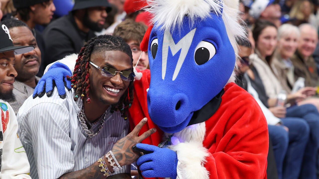 DALLAS, TX - DECEMBER 25: CeeDee Lamb smiles during the game with the Dallas Mavericks Mascot, Champ against the Los Angeles Lakers on December 25, 2022 at the American Airlines Center in Dallas, Texas. Mandatory Copyright Notice: Copyright 2022 NBAE