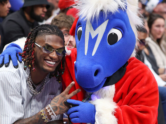 DALLAS, TX - DECEMBER 25: CeeDee Lamb smiles during the game with the Dallas Mavericks Mascot, Champ against the Los Angeles Lakers on December 25, 2022 at the American Airlines Center in Dallas, Texas. Mandatory Copyright Notice: Copyright 2022 NBAE