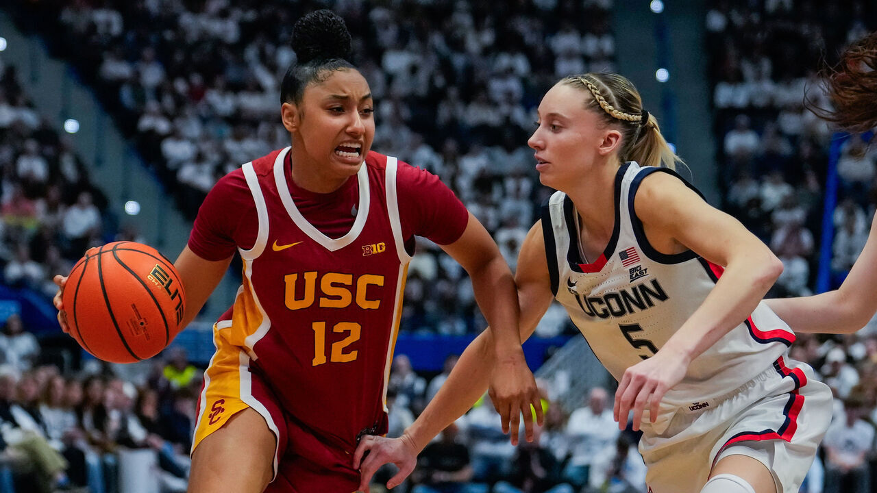 HARTFORD, CONNECTICUT - DECEMBER 21: JuJu Watkins #12 of the USC Trojans is defended by Paige Bueckers #5 and Morgan Cheli #23 of the Connecticut Huskies during the second half of an NCAA women's basketball game at the XL Center on December 21, 2024 in Hartford, Connecticut.