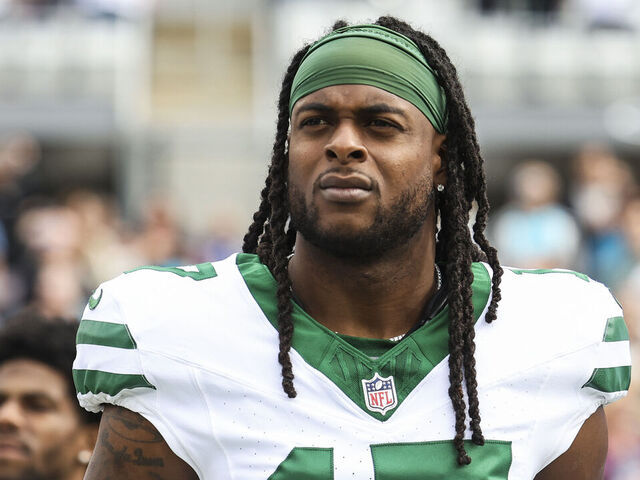 JACKSONVILLE, FLORIDA - DECEMBER 15: Davante Adams #17 of the New York Jets looks on from the sideline during the national anthem prior to an NFL football game against the Jacksonville Jaguars at EverBank Stadium on December 15, 2024 in Jacksonville, FL.