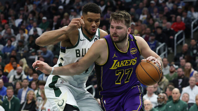 MILWAUKEE, WISCONSIN - MARCH 13: Luka Doncic #77 of the Los Angeles Lakers is defended by Giannis Antetokounmpo #34 of the Milwaukee Bucks during the second half of a game at Fiserv Forum on March 13, 2025 in Milwaukee, Wisconsin.