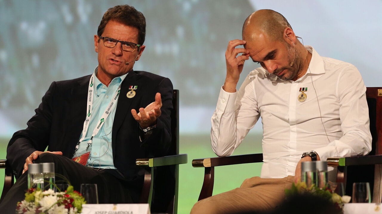 Russia's coach Italian Fabio Capello (L) and Bayern Munich's Spanish head coach Pep Guardiola attend the first session of the 8th Dubai International Sports Conference on December 28, 2013 in Dubai. AFP PHOTO/MARWAN NAAMANI