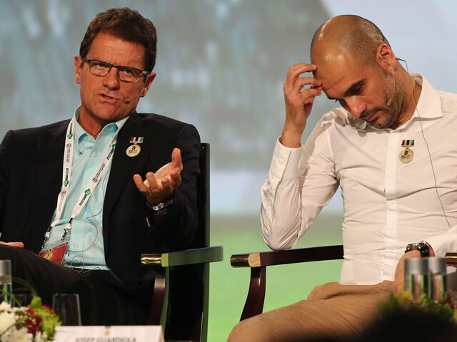 Russia's coach Italian Fabio Capello (L) and Bayern Munich's Spanish head coach Pep Guardiola attend the first session of the 8th Dubai International Sports Conference on December 28, 2013 in Dubai. AFP PHOTO/MARWAN NAAMANI