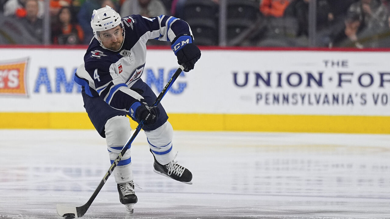 PHILADELPHIA, PENNSYLVANIA - MARCH 6: Neal Pionk #4 of the Winnipeg Jets passes the puck against against the Philadelphia Flyers at the Wells Fargo Center on March 6, 2025 in Philadelphia, Pennsylvania. The Jets defeated the Flyers 4-1.