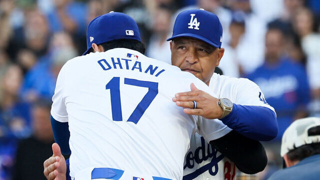 LOS ANGELES, CALIFORNIA - OCTOBER 13: Shohei Ohtani #17 of the Los Angeles Dodgers hugs Dave Roberts #30 during player introductions before game one of the National League Championship Series against the New York Mets at Dodger Stadium on Sunday, Oct. 13, 2024 in Los Angeles. (Robert Gauthier / Los Angeles Times via Getty Images)