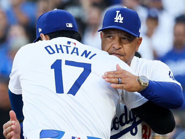 LOS ANGELES, CALIFORNIA - OCTOBER 13: Shohei Ohtani #17 of the Los Angeles Dodgers hugs Dave Roberts #30 during player introductions before game one of the National League Championship Series against the New York Mets at Dodger Stadium on Sunday, Oct. 13, 2024 in Los Angeles. (Robert Gauthier / Los Angeles Times via Getty Images)