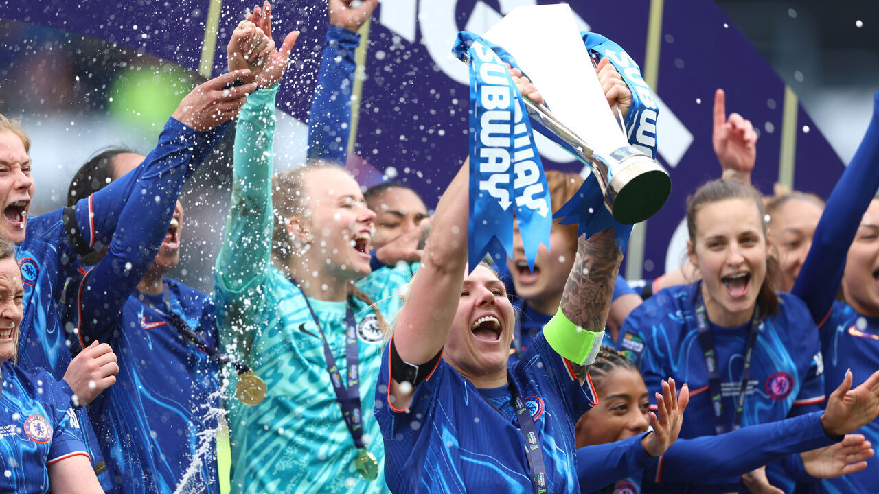 DERBY, ENGLAND - MARCH 15: Millie Bright of Chelsea lifts the Subway Women's League Cup after her team's victory in the Subway Women's League Cup Final match between Chelsea and Manchester City at Pride Park on March 15, 2025 in Derby, England.