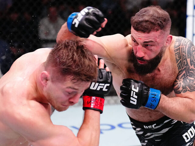 LAS VEGAS, NEVADA - MARCH 15: (R-L) Roman Dolidze of Georgia punches Marvin Vettori of Italy in a middleweight fight during the UFC Fight Night event at UFC APEX on March 15, 2025 in Las Vegas, Nevada.