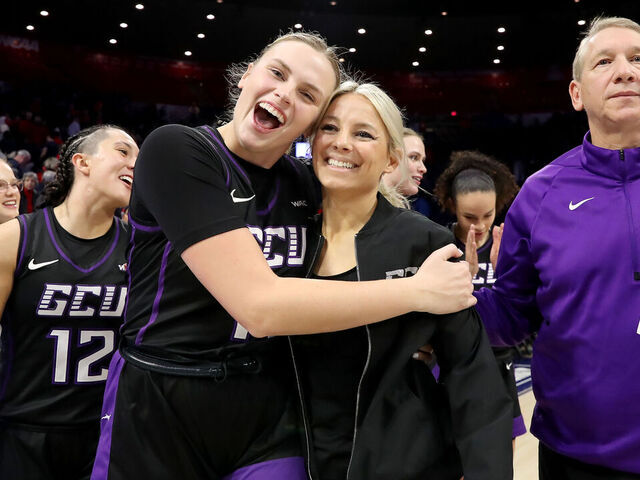 TUCSON, AZ - DECEMBER 05: Grand Canyon Antelopes guard Sydney Erikstrup #11 and head coach Molly Miller celebrate after defeating the Arizona Wildcats 69-66. December 5, 2024 at McKale Center in Tucson, AZ.