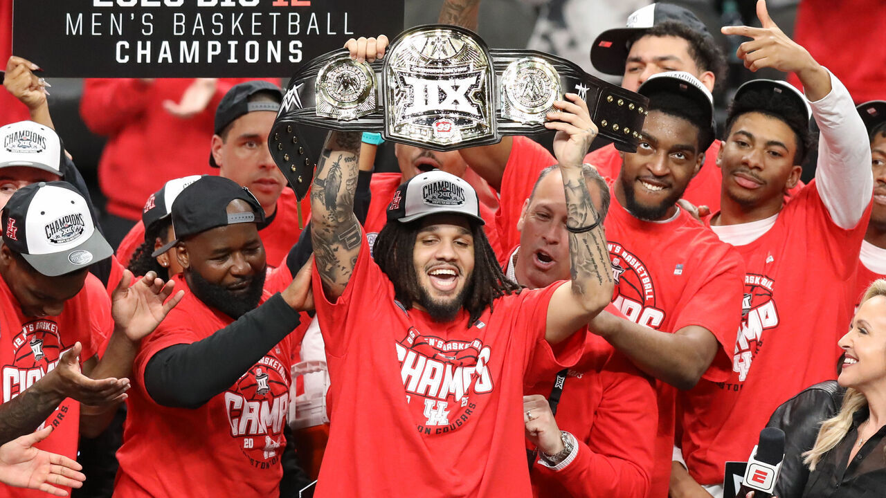 KANSAS CITY, MO - MARCH 15: Houston Cougars guard Emanuel Sharp (21) holds up the Most Outstanding Player belt after winning the Big 12 tournament final between the Arizona Wildcats and Houston Cougars on March 15, 2025 at T-Mobile Center in Kansas City, MO.