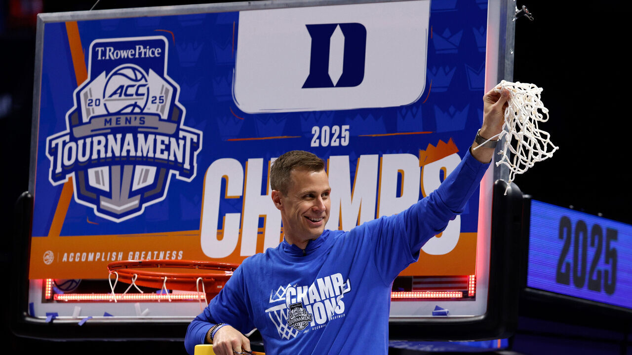 CHARLOTTE, NORTH CAROLINA - MARCH 15: Head coach Jon Scheyer of the Duke Blue Devils celebrates after cutting the net following their win against the Louisville Cardinals in the championship game of the ACC men's basketball tournament at Spectrum Center on March 15, 2025 in Charlotte, North Carolina.