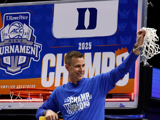 CHARLOTTE, NORTH CAROLINA - MARCH 15: Head coach Jon Scheyer of the Duke Blue Devils celebrates after cutting the net following their win against the Louisville Cardinals in the championship game of the ACC men's basketball tournament at Spectrum Center on March 15, 2025 in Charlotte, North Carolina.