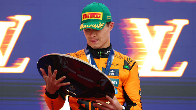 MELBOURNE, AUSTRALIA - MARCH 16: Race winner Lando Norris of Great Britain and McLaren inspects his trophy on the podium during the F1 Grand Prix of Australia at Albert Park Grand Prix Circuit on March 16, 2025 in Melbourne, Australia.