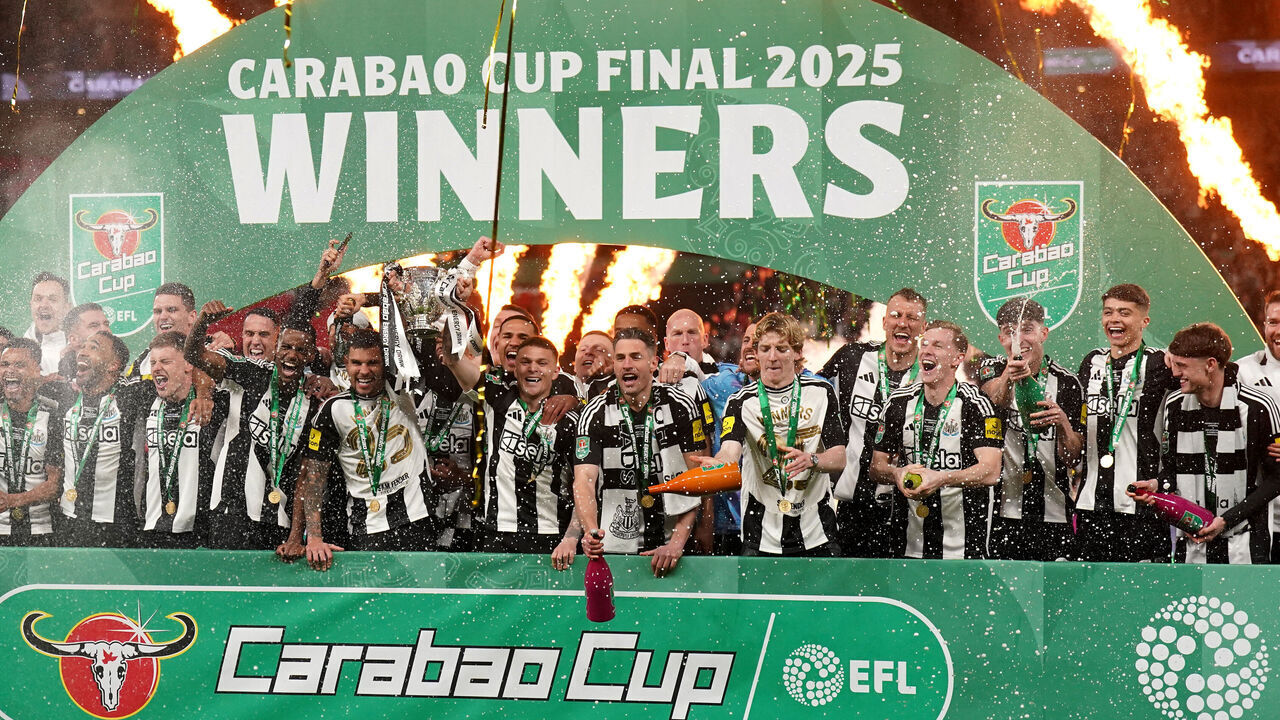 Newcastle United's Bruno Guimaraes and Kieran Trippier lift the Carabao Cup trophy with team-mates following victory in the Carabao Cup final at Wembley Stadium, London. Picture date: Sunday March 16, 2025.