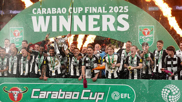 Newcastle United's Bruno Guimaraes and Kieran Trippier lift the Carabao Cup trophy with team-mates following victory in the Carabao Cup final at Wembley Stadium, London. Picture date: Sunday March 16, 2025.