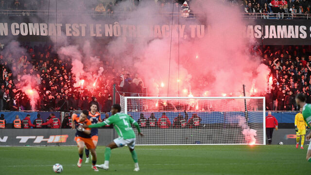 TOPSHOT - Montpellier's supporters light flares during the French L1 football match between Montpellier Herault SC and AS Saint-Etienne at Stade de la Mosson in Montpellier, southern France, on March 16, 2025.