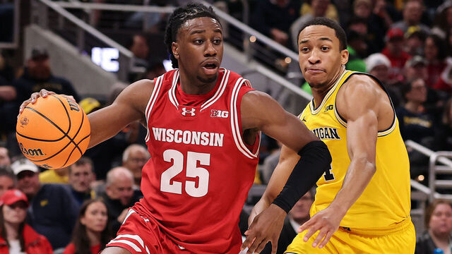 INDIANAPOLIS, INDIANA - MARCH 16: John Blackwell #25 of the Wisconsin Badgers drives to the basket against Nimari Burnett #4 of the Michigan Wolverines during the first half in the Big Ten men's basketball tournament championship at Gainbridge Fieldhouse on March 16, 2025 in Indianapolis, Indiana.