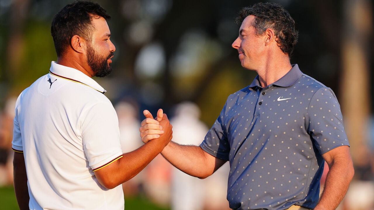 PONTE VEDRA BEACH, FL - MARCH 15: PGA golfers J.J. Spaun and Rory McIlroy shake hands after finishing on the 18th green during the third round of The Players Championship at the Stadium Course at TPC Sawgrass on March 15, 2025, at Ponte Verde Beach, Florida.