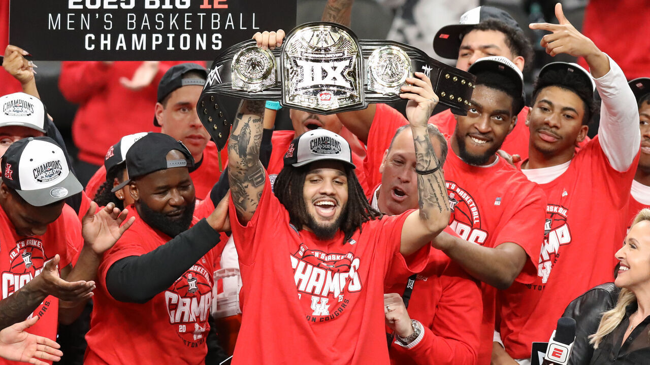 KANSAS CITY, MO - MARCH 15: Houston Cougars guard Emanuel Sharp (21) holds up the Most Outstanding Player belt after winning the Big 12 tournament final between the Arizona Wildcats and Houston Cougars on March 15, 2025 at T-Mobile Center in Kansas City, MO.