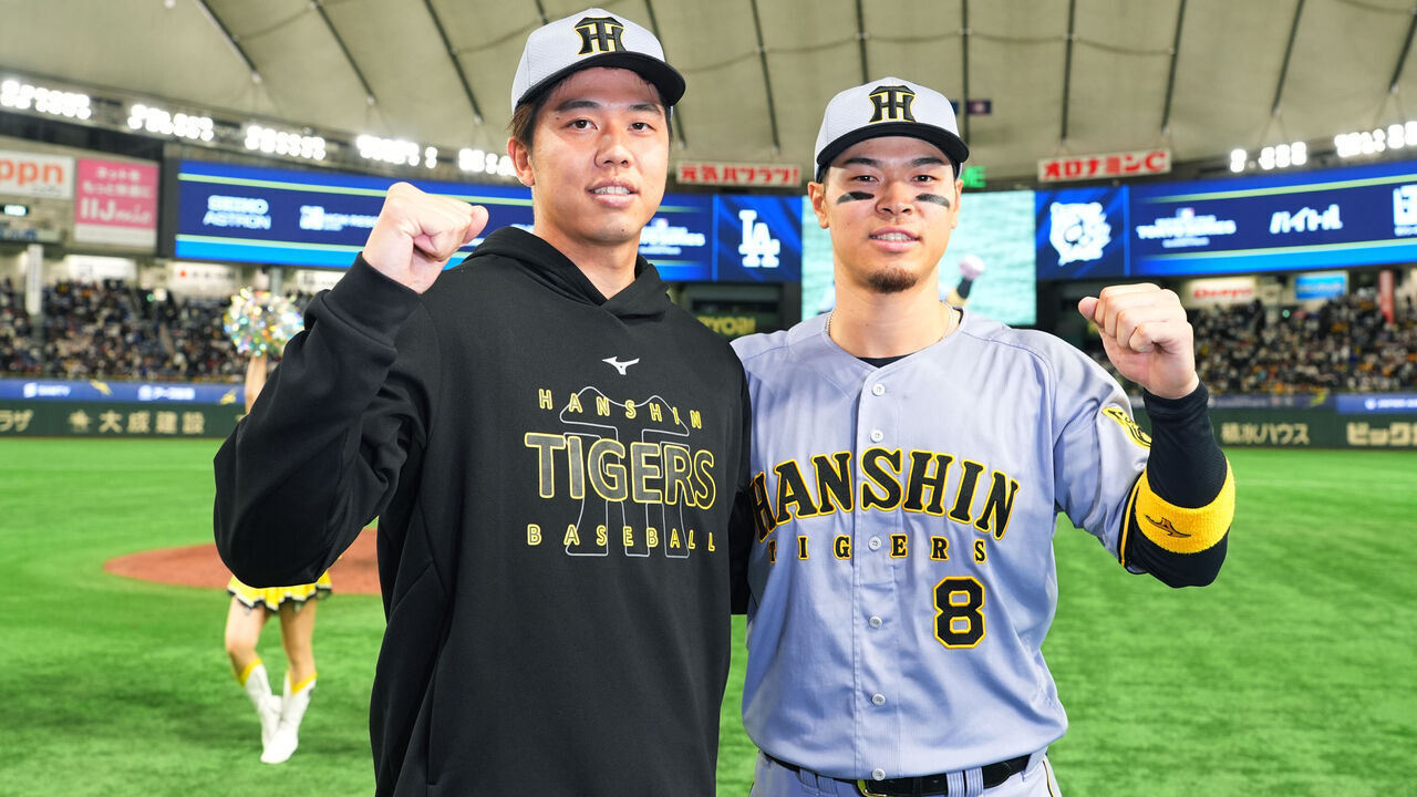 TOKYO, JAPAN - MARCH 16: Hiroto Saiki #35 and Teruaki Sato #8 of the Hanshin Tigers pose after the team's 3-0 victory against Los Angeles Dodgers at Tokyo Dome on March 16, 2025 in Tokyo, Japan.