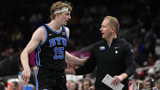 KANSAS CITY, MISSOURI - MARCH 14: Fousseyni Traore #45 of the Brigham Young Cougars talks with head coach Kevin Young in the semifinal game of the Big 12 men's basketball tournament game of the Big 12 against the Houston Cougars at T-Mobile Center on March 14, 2025 in Kansas City, Missouri.