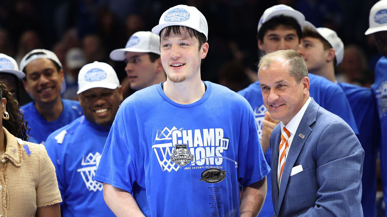 CHARLOTTE, NC - MARCH 15: Duke Blue Devils guard Kon Knueppel (7) gets the MVP trophy of the tournament presented by ACC commissioner Jim Phillips during the ACC Men's basketball tournament championship game between the Louisville Cardinals and the Duke Blue Devils on March 15, 2025 at the Spectrum Center in Charlotte, N.C.