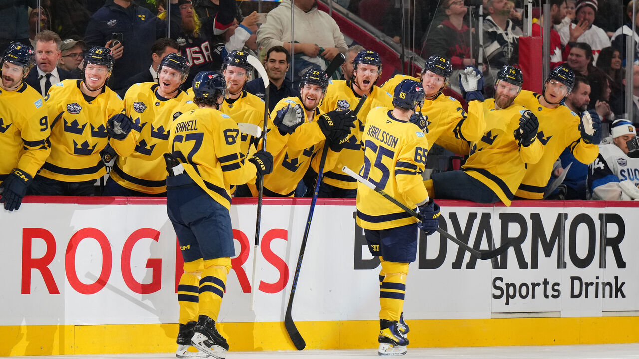 MONTREAL, QUEBEC - FEBRUARY 15: (L-R) Rickard Rakell #67 and Erik Karlsson #65 of Team Sweden skate by the team bench to celebrate with teammates after Karlsson scored a goal during the second period of the 4 Nations Face-Off game between Finland and Sweden at Bell Centre on February 15, 2025 in Montreal, Quebec.