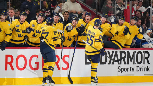 MONTREAL, QUEBEC - FEBRUARY 15: (L-R) Rickard Rakell #67 and Erik Karlsson #65 of Team Sweden skate by the team bench to celebrate with teammates after Karlsson scored a goal during the second period of the 4 Nations Face-Off game between Finland and Sweden at Bell Centre on February 15, 2025 in Montreal, Quebec.