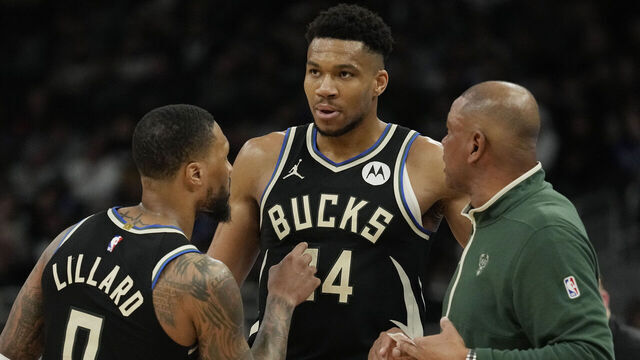 MILWAUKEE, WISCONSIN - APRIL 07: Damian Lillard #0, Giannis Antetokounmpo #34 and ead coach Doc Rivers of the Milwaukee Bucks talk during the first half of the game against the New York Knicks at Fiserv Forum on April 07, 2024 in Milwaukee, Wisconsin.