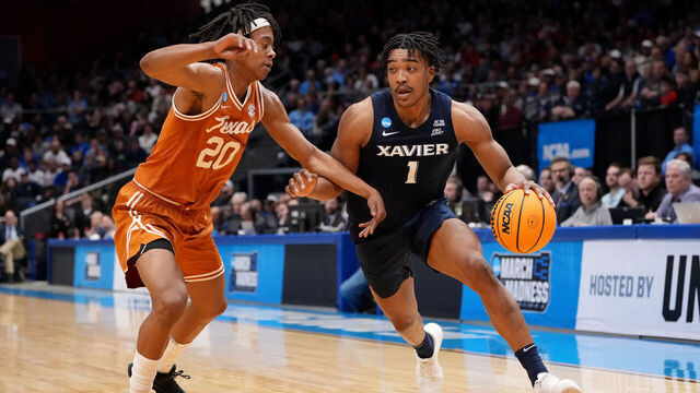 DAYTON, OHIO - MARCH 19: Marcus Foster #1 of the Xavier Musketeers drives the ball against the defense of Tre Johnson #20 of the Texas Longhorns during the first half in the First Four game of the NCAA Men's Basketball Tournament at University of Dayton Arena on March 19, 2025 in Dayton, Ohio.