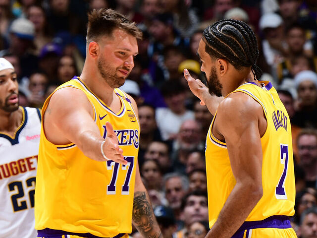 LOS ANGELES, CA - MARCH 19: Luka Doncic #77 high fives Gabe Vincent #7 of the Los Angeles Lakers during the game against the Denver Nuggets on March 19, 2025 at Crypto.Com Arena in Los Angeles, California. NOTE TO USER: User expressly acknowledges and agrees that, by downloading and/or using this Photograph, user is consenting to the terms and conditions of the Getty Images License Agreement. Mandatory Copyright Notice: Copyright 2025 NBAE
