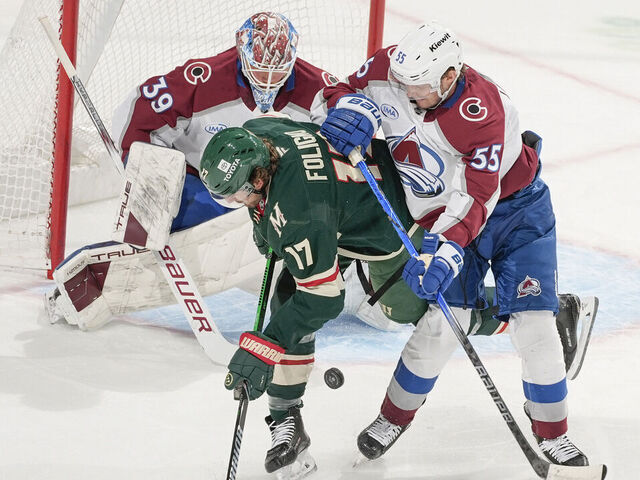 SAINT PAUL, MN - MARCH 11: Ryan Lindgren #55 and MacKenzie Blackwood #39 of the Colorado Avalanche defend their goal against Marcus Foligno #17 of the Minnesota Wild during the game at the Xcel Energy Center on March 11, 2025 in Saint Paul, Minnesota.
