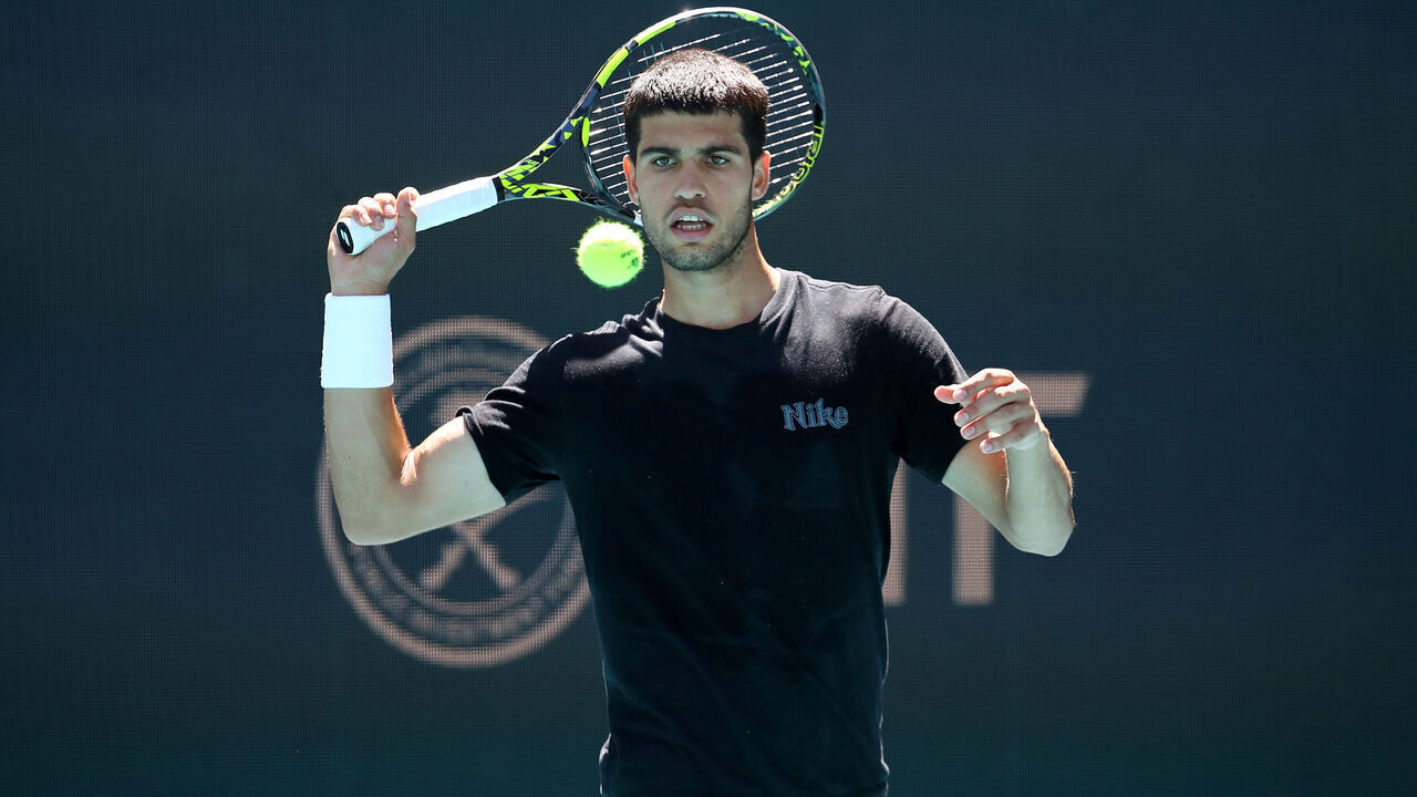 MIAMI GARDENS, FLORIDA - MARCH 18: Carlos Alcaraz returns a shot during a practice session on Day 1 of the Miami Open at Hard Rock Stadium on March 18, 2025 in Miami Gardens, Florida.