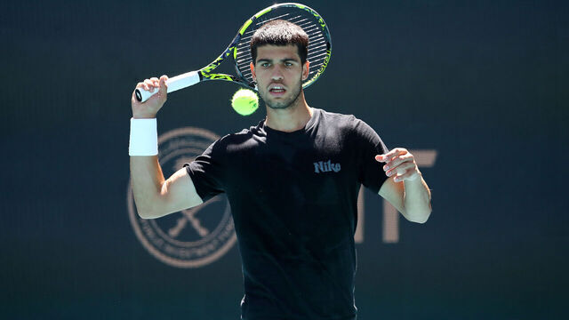 MIAMI GARDENS, FLORIDA - MARCH 18: Carlos Alcaraz returns a shot during a practice session on Day 1 of the Miami Open at Hard Rock Stadium on March 18, 2025 in Miami Gardens, Florida.