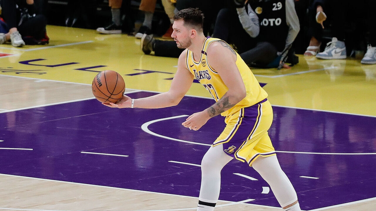 LOS ANGELES, CA - MARCH 19: Los Angeles Lakers guard Luka Doncic (77) looks to pass during the Denver Nuggets vs Los Angeles Lakers NBA game on March 19, 2025, at Crypto.com Arena in Los Angeles, CA.