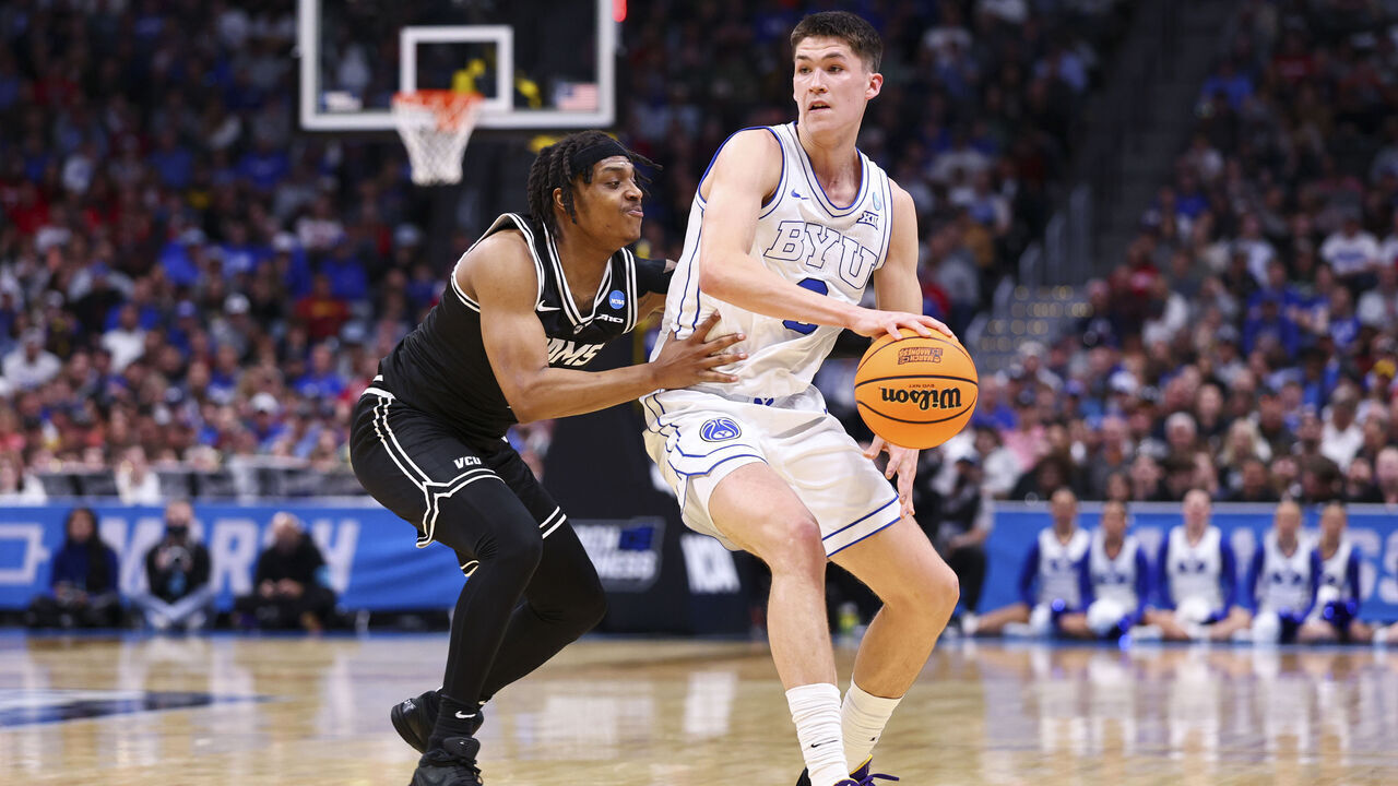 DENVER, COLORADO - MARCH 20: Egor Demin #3 of the Brigham Young Cougars is defended by Phillip Russell #1 of the Virginia Commonwealth Rams during the first round of the 2025 NCAA Men's Basketball Tournament held at Ball Arena on March 20, 2025 in Denver, Colorado.