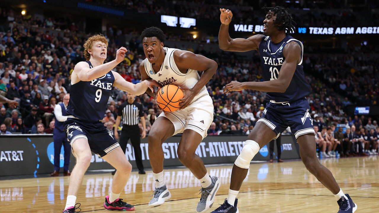 DENVER, COLORADO - MARCH 20: Pharrel Payne #21 of the Texas A&M Aggies is fouled by Riley Fox #9 of the Yale Bulldogs as Samson Aletan #10 look son during the second half in the first round of the NCAA Men's Basketball Tournament at Ball Arena on March 20, 2025 in Denver, Colorado.