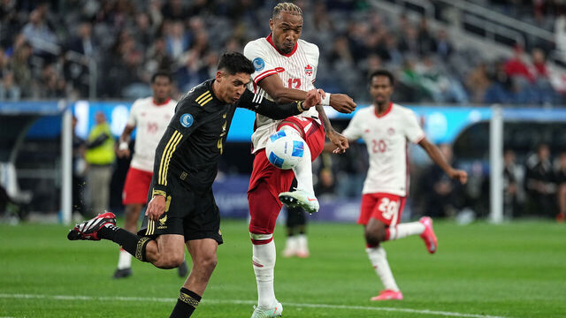 INGLEWOOD, CALIFORNIA - MARCH 20: Derek Cornelius #13 of Canada shoots against Edson Álvarez #4 of Mexico during the first half of a CONCACAF Nations League semifinal match at SoFi Stadium on March 20, 2025 in Inglewood, California.