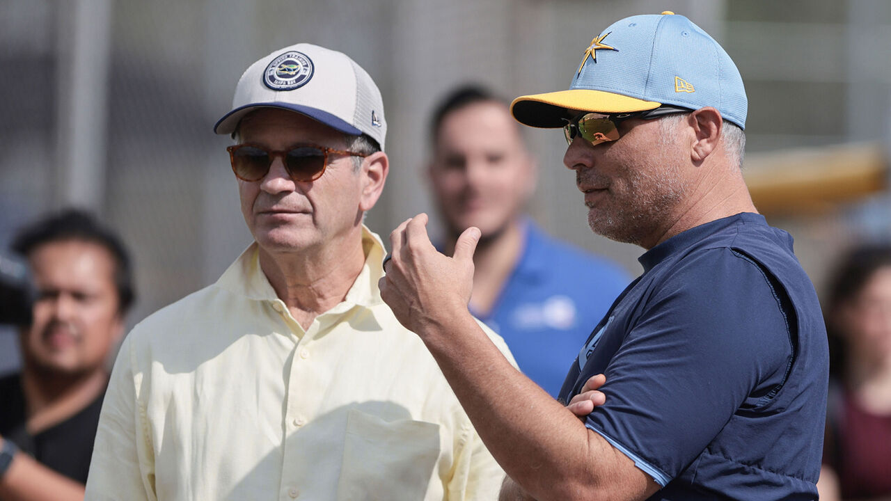 Tampa Bay Rays principal owner Stuart Sternberg and Manager Kevin Cash watch as pitchers and catchers hold their first Spring Training workout in Port Charlotte, Florida, on February 12, 2025, at Charlotte Sports Park. Hurricane Milton rips the roof off Tropicana Field in St. Petersburg, Florida, where the Rays usually play their regular season games. They play their regular season home games this year at the New York Yankees Spring Training stadium, Steinbrenner Field, which seats 11,000 people.