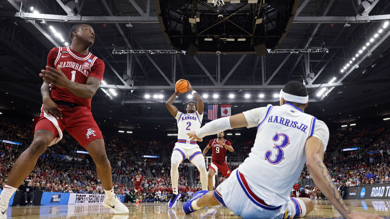 PROVIDENCE, RHODE ISLAND - MARCH 20: AJ Storr #2 of the Kansas Jayhawks controls the ball ahead of Johnell Davis #1 of the Arkansas Razorbacks during the second half in the first round of the NCAA Men's Basketball Tournament at Amica Mutual Pavillion on March 20, 2025 in Providence, Rhode Island.